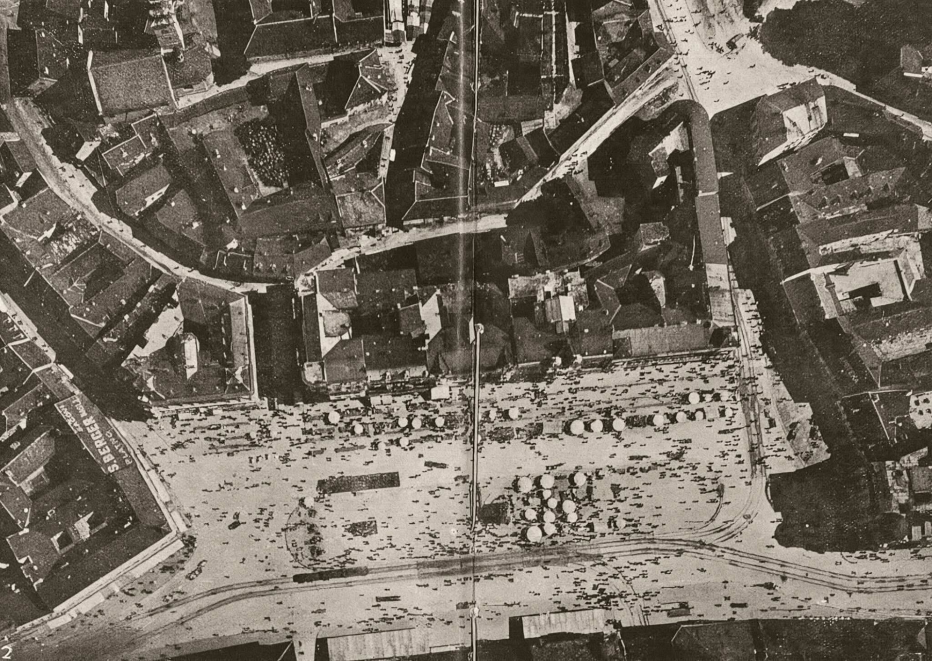 Aerial view of Ban Jelačić Square filled with market stalls, the Sberger building at left