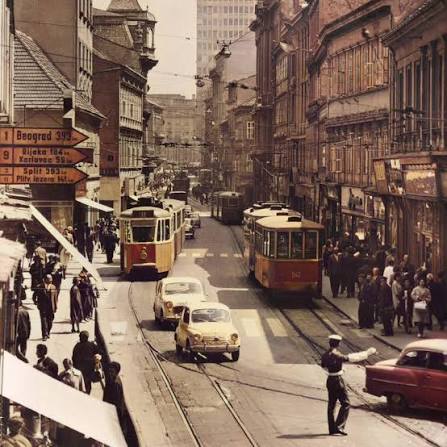 Orange trams and busy pavements in the city centre
