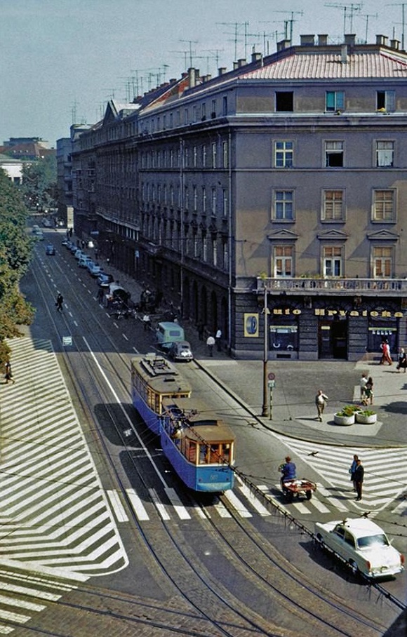 A blue tram passing the Auto Hrvatska building